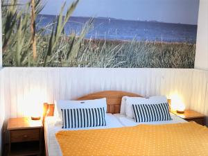 a bedroom with a bed with a view of the ocean at Haus Wattenloeper in Cuxhaven
