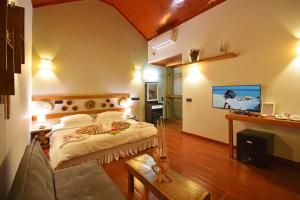 Säng eller sängar i ett rum på Beach Villa Ukulhas