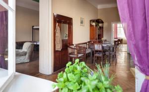 a dining room and living room with a table and chairs at Hostel Fleda in Brno