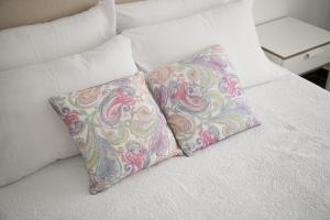 two pillows sitting on top of a bed at Apartamentos Gama in Cala Galdana