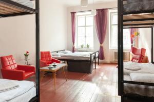 
a bedroom with two beds and a desk at Hostel Fleda in Brno
