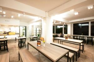 a restaurant with tables and chairs and a kitchen at a&o Bremen Hauptbahnhof in Bremen