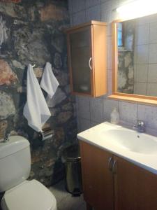 a bathroom with a toilet and a sink at Stonehouse 2 Bedroom Chalet on Olympus Amazing View in Pétra