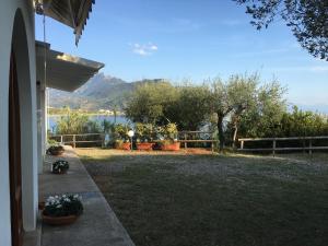 a house with a yard with a view of the water at Case Vacanze Torre Petrosa in Villammare +21 photos