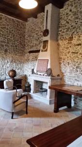 a living room with a fireplace and a table at Residenza d'Epoca Borgodifiume in Fiumefreddo Bruzio