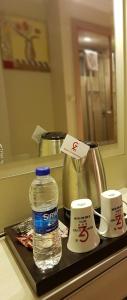 a bottle of water sitting on a tray on a counter at Grand Zeybek Hotel in İzmir