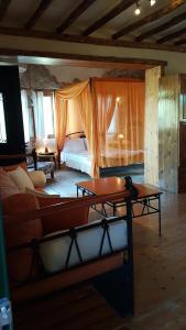 a living room with a bed and a couch at Castello Bellos Tower in Keri
