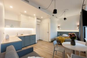 a kitchen and living room with a bed and a table at 9010 Apartments in Vilnius