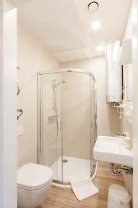 a bathroom with a shower and a toilet and a sink at 9010 Apartments in Vilnius +36 photos