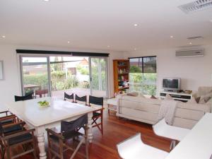 a living room with a table and a couch at Do Drop Inn - Port Willunga - C21 SouthCoast Holidays in Port Willunga