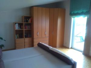 a bedroom with a bed and a book shelf at Ferienhaus Stadio in Angermünde