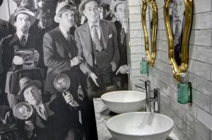 a bathroom with a painting of a group of men at Best Western Plus Nottingham Westminster Hotel in Nottingham