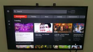 a television screen with several movies on it at The Octagon Ipoh - Home Stay in Ipoh +2 photos