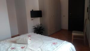 a bedroom with a bed with a towel on it at L'abete in Guspini