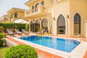 a swimming pool in the backyard of a house at SEA and ATLANTIS VIEW BEACHFRONT PALATIAL 4 BR VILLA PRIVATE SAUNA POOL BEACH PALM JUMEIRAH in Dubai