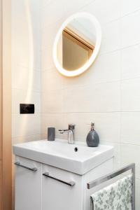 a bathroom with a white sink and a mirror at B&B Cozy Cove in Torre del Greco