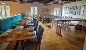 a dining room with wooden tables and chairs at Solar da Bica in São Vicente +31 photos