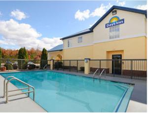 a large swimming pool in front of a hotel at Days Inn by Wyndham Lincoln in Lincoln