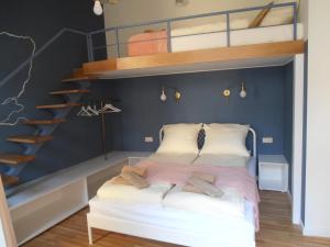 a bedroom with a bunk bed and a ladder at Apartamenty Rudi in Krakow