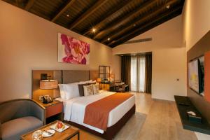 a hotel room with a large bed and a couch at Lemon Tree Premier, Corbett in Garjia