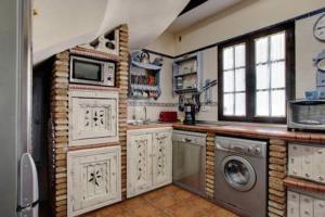 una cocina con lavadora y secadora. en Vivienda Rural la Terracita, en Montejaque