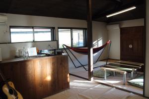 a room with a hammock in the middle of a room at Guest House Yukari in Tsuru 