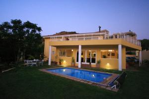 a house with a swimming pool in front of it at Villa Moringa Guesthouse in Windhoek