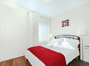 a white bedroom with a red blanket on a bed at Moana Magic - C21 SouthCoast Holidays in Moana +7 photos