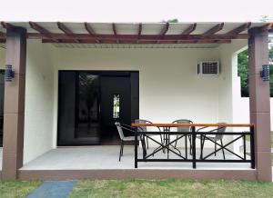 a patio with a table and chairs on it at Positano Alona Beach Panglao in Panglao