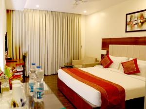 Ένα ή περισσότερα κρεβάτια σε δωμάτιο στο Hotel Tridev