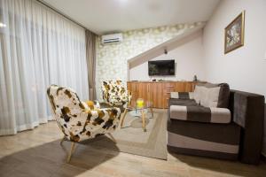TV a/nebo společenská místnost v ubytování Apartmani MG