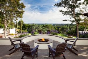 a patio with two chairs and a fire pit at Chaminade Resort & Spa in Santa Cruz