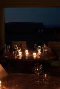 a table with candles and wine glasses on it at Fosshotel Nupar in Kálfafell