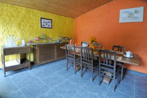 a dining room with a wooden table and chairs at Hotel Restaurant La Ferme de Grambais in Nivelles