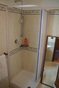 a shower with a glass door in a bathroom at MaMaViHouse in Rome