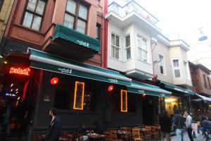 a restaurant on a city street with people walking around at Moda Hostel in Istanbul