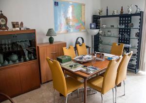 a dining room with a wooden table and yellow chairs at B&B Borfuro in Bergamo
