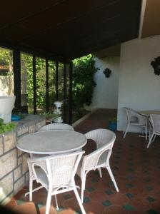 a patio with a table and chairs and windows at Casa Dos Oliva in Alcobaça