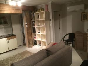a person sitting on a couch in a living room at Titirangi Paradiso in Titirangi +16 photos