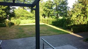 a view of a garden from a window at Ferienwohnung Berger in Greven