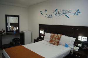 Säng eller sängar i ett rum på Hotel Arawak Upar