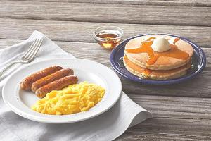 a plate of breakfast food with eggs and pancakes at Bali Diva Hotel Kuta in Kuta