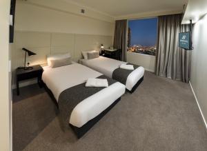 En eller flere senge i et værelse på Woodroffe Hotel