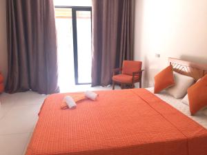 a bedroom with a bed with two towels on it at West Front One No 4 with SEAFRONT - LICENSED BY TOURISM AUTHORITY 14977 Flic en Flac Mauritius in Flic-en-Flac