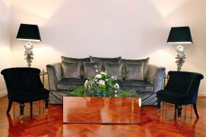 a living room with a couch and two chairs at Boutike Cibeles in Madrid
