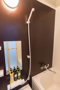 a bathroom with a toilet and a mirror at Bijou Suites Nagomi in Osaka