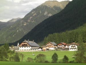 a group of buildings in front of a mountain at Haus Schaller in Valle Di Casies