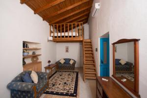 a living room with a staircase and a mirror at Original Villa Petros in Symi