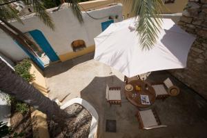 an overhead view of a white umbrella and some chairs at Original Villa Petros in Symi