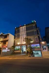 a tall building with lights on top of it at night at Grand Puri Saron Yogyakarta in Yogyakarta